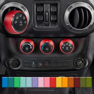 May include: Red car interior control knobs and vent trim. The knobs have black detailing and white icons. The vent trim is silver. The image also shows a colour palette of various colours.