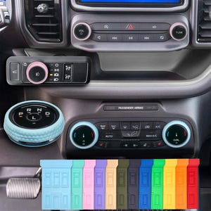 May include: Interior car accessories in various colors. The image shows a gear shift knob, control panel accents, and switch panel with pink and blue accents. A row of colored door sill protectors are at the bottom.