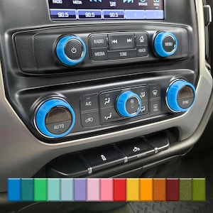 May include: Bright blue control knob covers for a vehicle's dashboard. The image shows several knobs with the word "AUTO", "SYNC", and "MENU" visible. A colour palette of various hues is displayed at the bottom of the image.