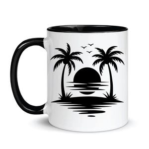 May include: White ceramic mug with a black interior and handle. The mug features a black silhouette design of a sunset over the ocean with palm trees and birds. A perfect gift for beach lovers.