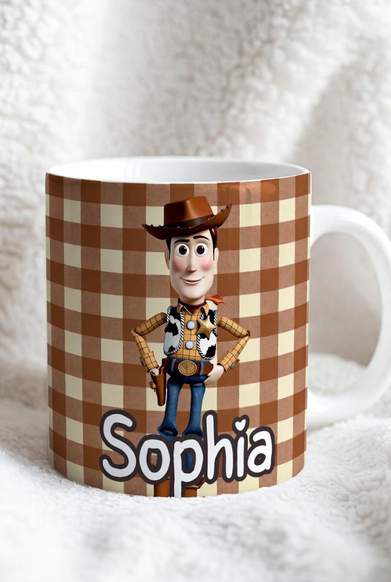 May include: A white ceramic mug featuring a brown and cream gingham pattern background. The mug displays a graphic of a cowboy character wearing a brown hat, yellow shirt, and cow-print vest. The name Sophia is printed in large white letters.