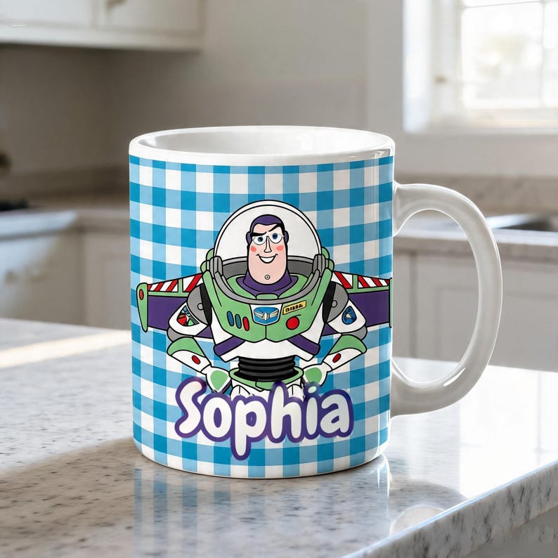 May include: A white ceramic mug featuring a blue and white gingham checkered pattern background. The mug displays a colorful illustration of the character Buzz Lightyear from Toy Story, with the name Sophia printed in purple script below.