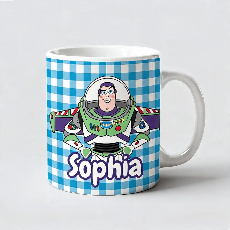 May include: A white ceramic mug featuring a blue and white checkered pattern background. The center displays a cartoon illustration of a space ranger character in a green, white, and purple suit. The name Sophia is printed in purple below.