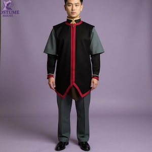 May include: A black costume with red trim and a gold collar, paired with gray pants. The costume has a long, tunic-style top with a red zipper and a unique angular hemline. The sleeves are gray, and the outfit is completed with matching gray pants.