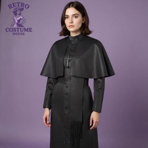 May include: A black costume from Retro Costume House. The outfit includes a long dress with a row of buttons, a cape, and a cross pendant. The Retro Costume House logo is in the upper left corner. The background is a solid purple.