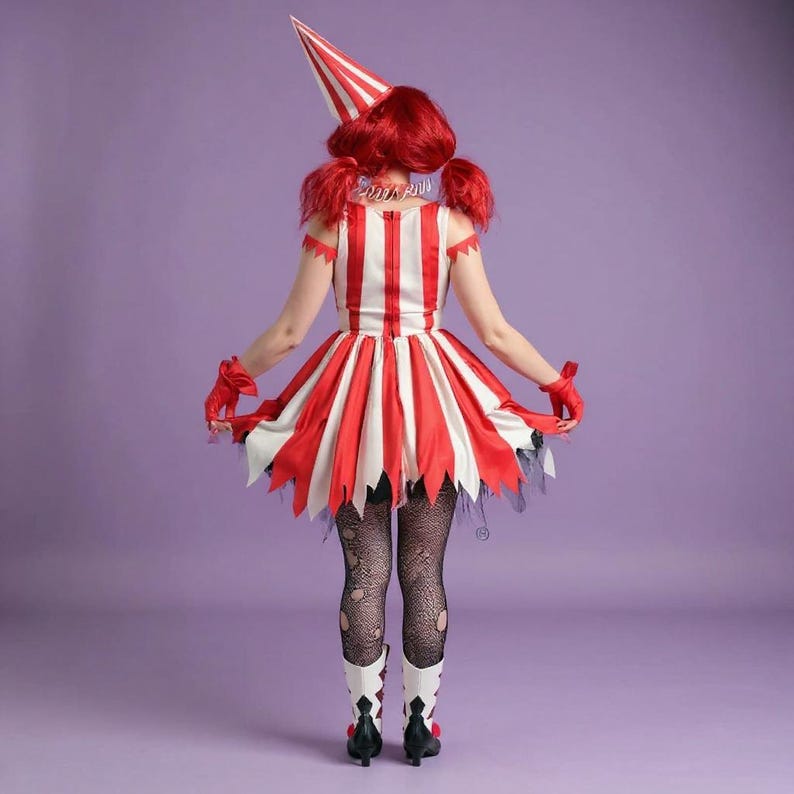 May include: A red and white striped costume with a matching hat. The dress has a flared skirt with jagged edges, paired with black fishnet stockings and white boots with black accents. The costume is set against a purple background.