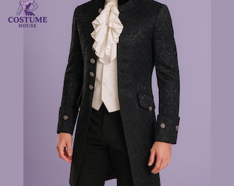 May include: A black, patterned frock coat with a high collar, worn over a white shirt with a ruffled ascot. The coat has decorative buttons and is part of a costume. The logo for Retro Costume House is in the upper left corner.