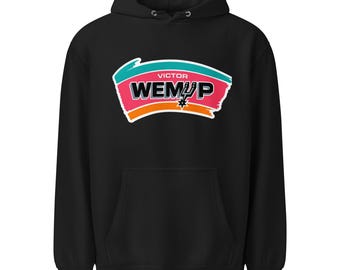 May include: Black hoodie with a front graphic featuring the text "VICTOR WEMÜp" in white and pink, with a teal and orange design. The hoodie has a drawstring hood and a front pocket.