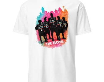 May include: White t-shirt featuring a colorful graphic of five basketball players in silhouette, with the text "THE BOYS" at the bottom. The players are in black uniforms with the words "San Antonio" and numbers 1, 2, 3, 4, and 5.