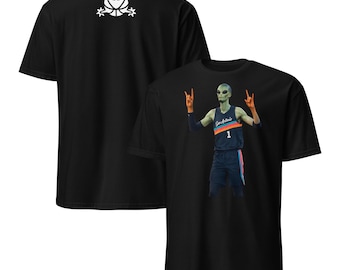 May include: Black t-shirt featuring a graphic of an alien basketball player in a San Antonio jersey with the number 1. The back of the shirt has a white alien logo. The alien is making a rock and roll hand gesture.
