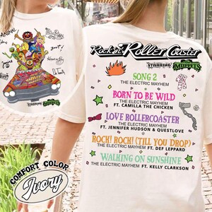 May include: Ivory t-shirt with a Muppets roller coaster graphic and song titles like "Born to be Wild". The text includes "Rockin' Roller Coaster" and "Comfort Color Ivory".
