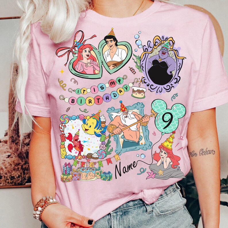 Puede incluir: Camiseta rosa con personajes de La Sirenita de Disney. El dise&ntilde;o tiene un tema de cumplea&ntilde;os con el texto "It's My Birthday" y un globo con el n&uacute;mero 9. Varios personajes est&aacute;n enmarcados en bordes decorativos.