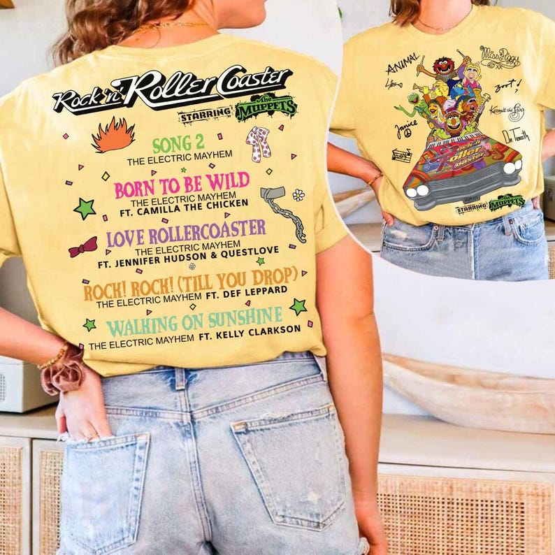 May include: Yellow t-shirt with "Rockin' Roller Coaster Starring The Muppets" printed on it. The front displays a Muppets graphic in a car. The back lists song titles including "Born to be Wild" and "Walking on Sunshine."