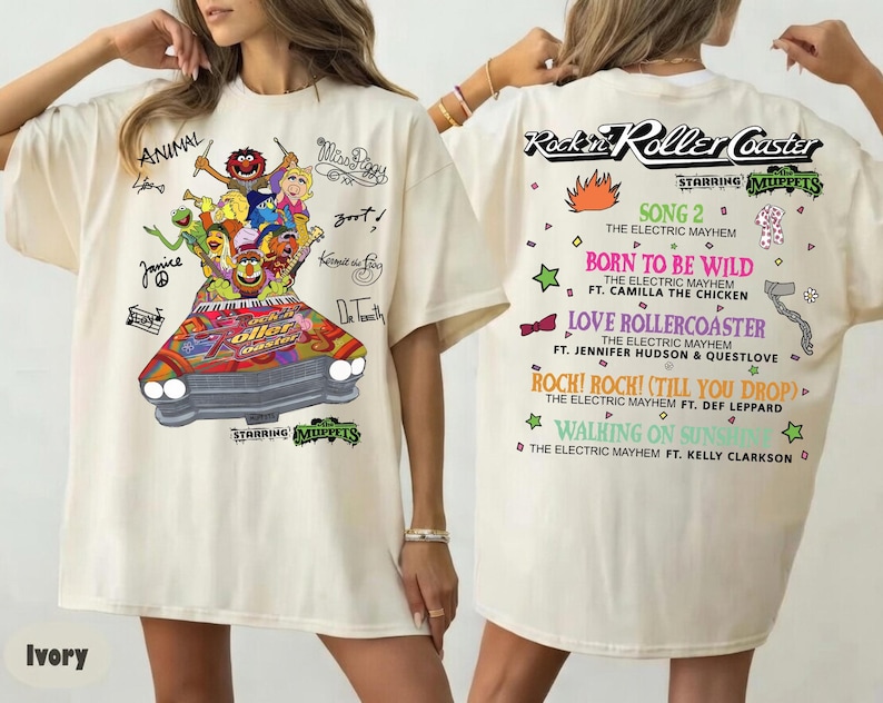 May include: Ivory t-shirt with a colourful graphic of the Muppets in a car and the text "Rockin' Roller Coaster". The back of the shirt lists song titles and artist names. The shirt is a short-sleeved, oversized style.