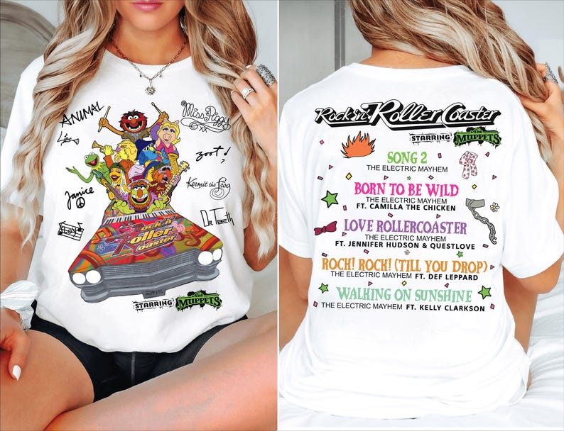 May include: White t-shirt with a vibrant graphic of the Muppets in a car, labelled "Rockin' Roller Coaster." The front has character signatures. The back lists song titles and artists. A fun, musical themed apparel item.