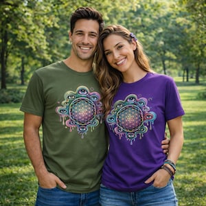 May include: Two short-sleeved t-shirts, one olive green and one purple, featuring a colorful, psychedelic design. The design includes a geometric flower of life pattern surrounded by eyes and dripping paint. The shirts are worn by two people.