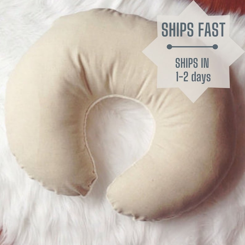 A natural colored linen and white chenille minky nursing pillow cover sits on a white backdrop