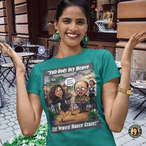May include: Teal t-shirt featuring a cartoon illustration with the text "Full-Body Dry Heave" and "The Newest Dance Craze!". The graphic depicts a dancing woman and a man holding a tray of food. The shirt has a crew neck.