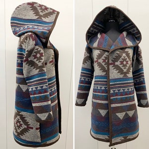 May include: A long, hooded cardigan with a geometric pattern in shades of brown, blue, and red. The cardigan has a shawl collar and a tie closure.