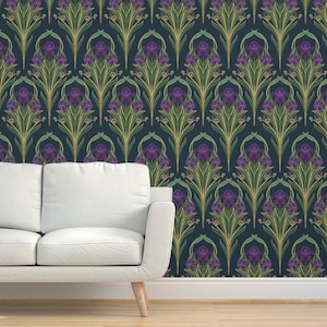 May include: Dark blue wallpaper with a repeating floral pattern. The design features stylized purple flowers, green leaves, and gold accents. The wallpaper is set against a dark blue background. A white sofa is in the foreground. The pattern is reminiscent of Art Nouveau.