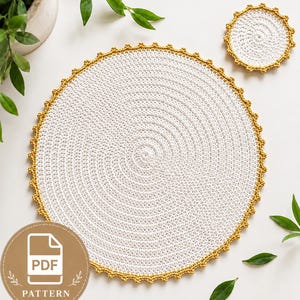 May include: A large circular white crochet placemat and a smaller matching circular white crochet coaster, both featuring a textured spiral stitch pattern and a decorative mustard yellow scalloped border edge, accompanied by a PDF pattern icon.
