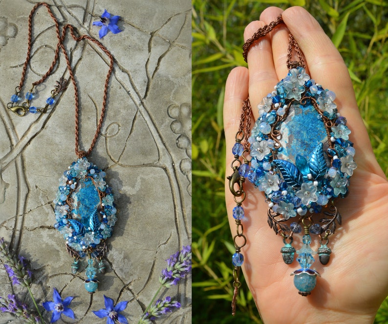 Necklace pictured on a hand for scale, and laid flat on a surface to display the chain. Close up shows the copper leaves, acorns and beaded pendants underneath the main pendant.