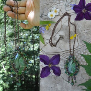 Green wire wrap necklace of similar size, to demonstrate scale. Shown in a hand, and worn. The pendant hands low on a thin copper chain, mid-chest. chain is adjustable.