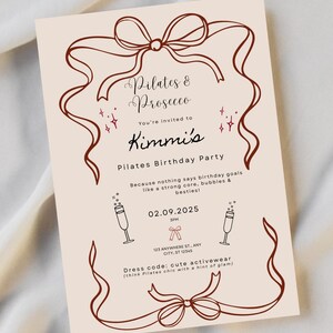 May include: A beige invitation with brown ribbon and text. The text reads "Pilates & Prosecco" and "Kimmi's Pilates Birthday Party." The date is 02.09.2025, with a dress code of cute activewear.