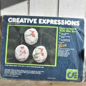 May include: A punch needle kit for making three polar bear ornaments. The kit includes white fabric, yarn, and instructions. The ornaments are approximately 3.5 inches by 4.5 inches.
