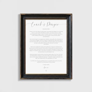 May include: Framed print with a black and gold distressed frame. The print features the text "Coach's Prayer" in elegant script, followed by a prayer. The text is in black on a white background. A cross is at the bottom.