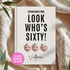 May include: A white hardcover book with the black text ESTABLISHED 1966 LOOK WHO'S SIXTY! and the name Victoria in script. The cover features three identical circular photos of a smiling person with short blonde hair and a pink star-shaped sticker.