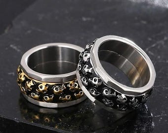 Anillo giratorio de calavera punk gótica - Acero inoxidable de 17 g, banda de 12 mm de ancho con relieve 3D - Color plata o dorado
