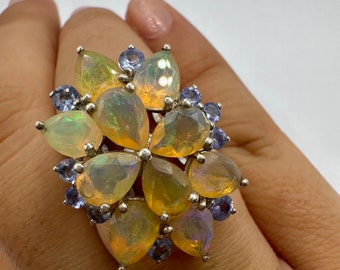 Vintage Orange Ethiopian Fire Opal surrounded by Blue Tanzanite Sterling Silver Rhodium Ring