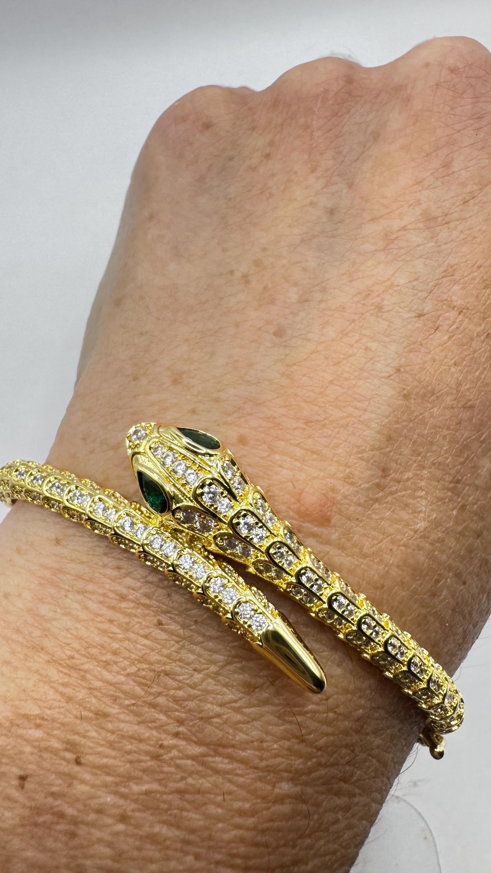 Vintage slangenarmband goud afgewerkt brons groene kristallen ogen