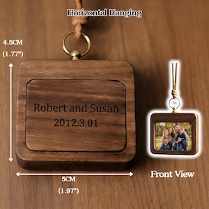 May include: A wooden square-shaped photo frame with a family photo, and a larger wooden square with the engraved text "Robert and Susan 2012.3.01". The frame is 5 cm (1.97") wide and 4.5 cm (1.77") tall. It has a leather cord for hanging.
