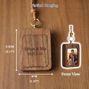 May include: A wooden photo frame with a leather strap for vertical hanging. The frame is 5.5 cm (2.17") tall and 4 cm (1.57") wide. The text "Ethan & Mia 2025.5.01" is engraved on the frame. A smaller frame shows a couple's photo.