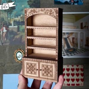 laser cut dollhouse bookshelf with intricate engravings and scalloped shelves