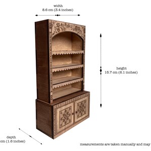 laser cut dollhouse bookshelf with intricate engravings and scalloped shelves