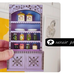 laser cut dollhouse bookshelf with intricate engravings and scalloped shelves