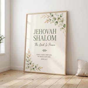 Puede incluir: Un cuadro decorativo con el texto JEHOVAH SHALOM, The Lord Is Peace, y el versículo JOHN 14:27, PEACE I LEAVE WITH YOU; MY PEACE I GIVE YOU. El diseño incluye hojas verdes y pequeñas flores pintadas al estilo acuarela en las esquinas.