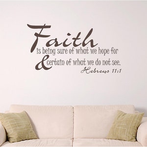 May include: A wall decal with the word "Faith" in a cursive font, followed by the quote "is being sure of what we hope for & certain of what we do not see." The text "Hebrews 11:1" is below the quote. The decal is brown and is on a white wall.