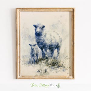 May include: A framed print featuring a sheep and a lamb in a field, rendered in shades of blue and white. The artwork has a vintage aesthetic, with visible brushstrokes and a distressed gold frame. The print is from Fern Cottage Prints.