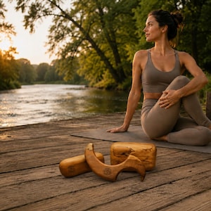 May include: A woman in a yoga pose on a mat, with wooden yoga props in the foreground. The props include a wooden yoga block, a wooden yoga wheel, and a wooden yoga arch. The woman is wearing a matching sports bra and leggings.