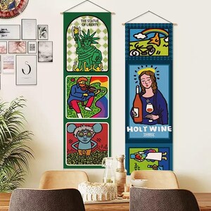May include: Two vertical fabric wall hangings featuring colorful pop art illustrations. The left banner displays the Statue of Liberty, a violinist, and a mouse character. The right banner features a rainbow, a figure holding wine labeled HOLY WINE.