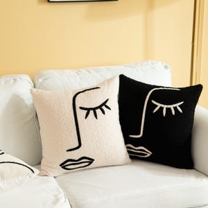 May include: A white ceramic mug with a black handle and the text "But First, Coffee" in a bold, black font. The mug is sitting on a wooden surface. The mug is approximately 4 inches tall.