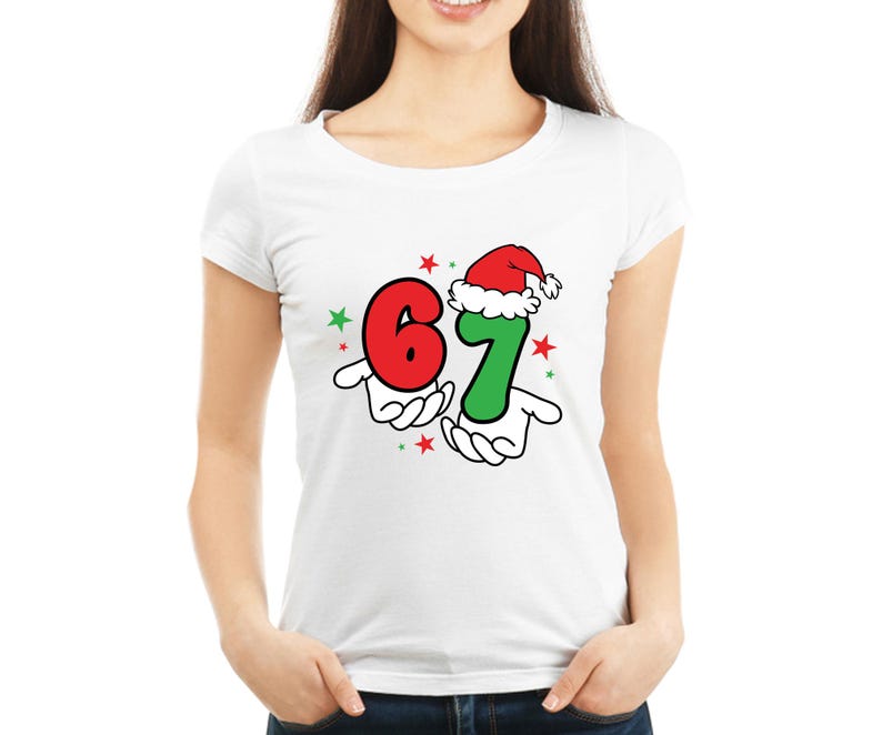 May include: White t-shirt featuring a festive graphic with the numbers 6 and 7. The number 7 is wearing a Santa hat. The numbers are held by cartoon hands, with red and green stars scattered around the design. A fun, holiday-themed tee.