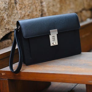 Handcrafted Black Epsom leather men's Clutch. It has a combination lock and a small handle.