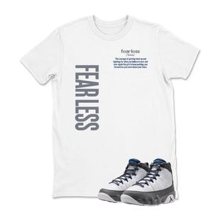May include: White t-shirt with the word "FEARLESS" printed vertically in gray on the left side. The word "fearless" is printed in a smaller font at the top center, with a definition below it. A pair of white, gray, and navy blue sneakers are at the bottom.
