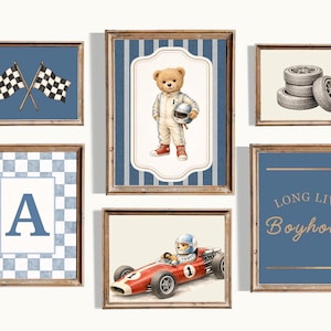 May include: A collection of framed wall art with a racing theme. The art includes checkered flags, a teddy bear in a racing suit, a race car, tires, and the text "LONG LIVE Boyhood". The frames are wood.