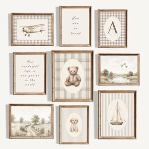 May include: A gallery wall set of nine framed prints in wooden frames. The prints feature a vintage aeroplane, a teddy bear, a sailboat, a puppy, landscapes, and text including "You are so loved" and "How wonderful life is now you're in the world."